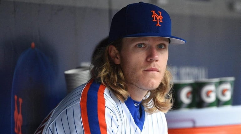 New York Mets starting pitcher Noah Syndergaard looks on from...