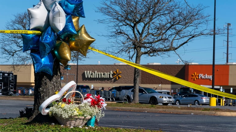 Flowers and balloons have been placed near the scene of...