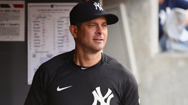 Yankees manager Aaron Boone looks on before an MLB game...