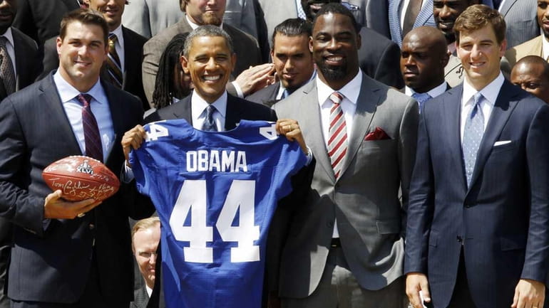 President Barack Obama poses with New York football Giants captains,...