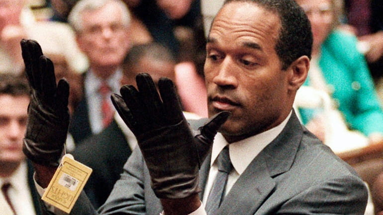 In this June 21, 1995 file photo, O.J. Simpson holds...
