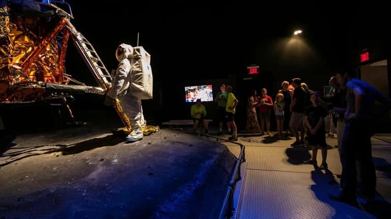 Attendees view the Grumman lunar module at the Cradle of...