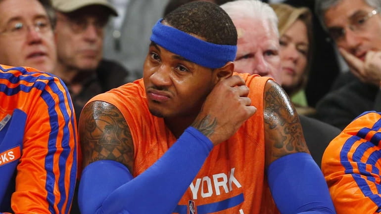 Carmelo Anthony of the Knicks sits on the bench during...