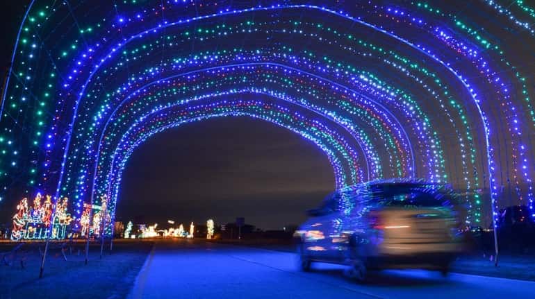A large, colorful, lighted tunnel at the Holiday Light Spectacular...