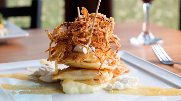 Grandma's pierogi comes topped with crispy fried onions, with applesauce and...