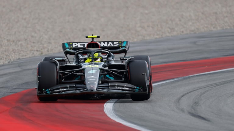 Mercedes driver Lewis Hamilton of Britain steers his car through...