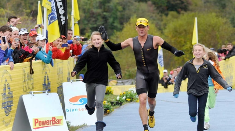 Lance Armstrong crosses the finish line of the Rev3 Half...