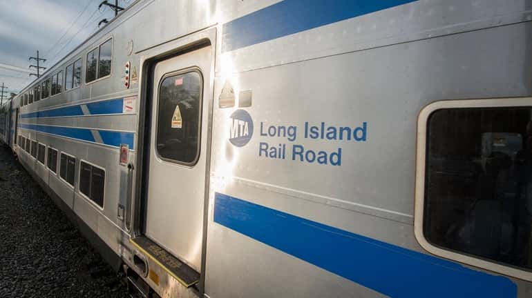 A bi-level Long Island Rail Road commuter train enters the Oakdale...
