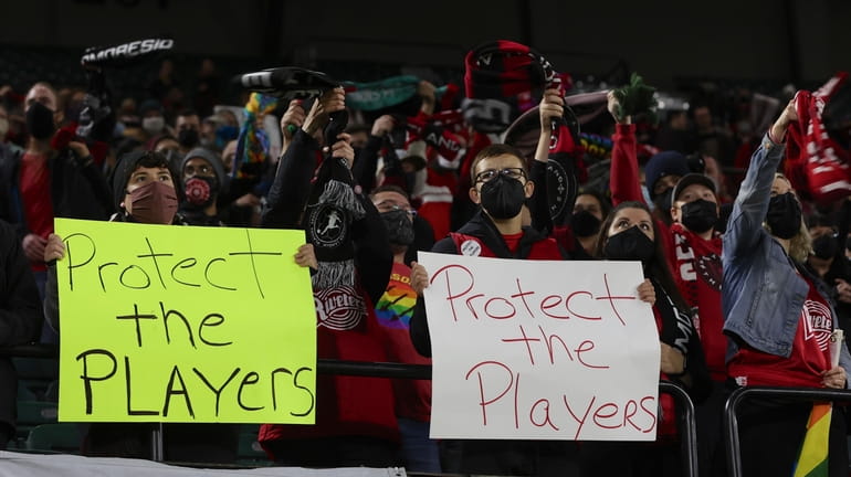 FILE - Portland Thorns fans hold signs during the first...