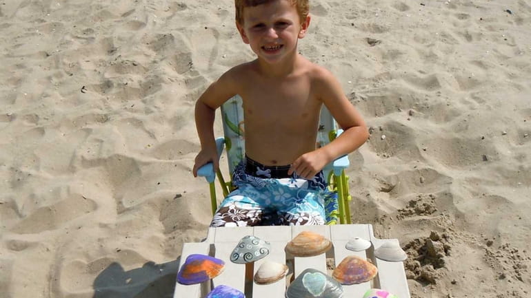 Matthew DeCicco, 4, of Hewlett sells painted sea shells to...