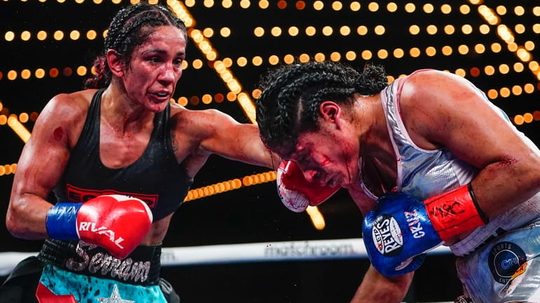 Amanda Serrano, left, punches Erika Cruz during the ninth round...