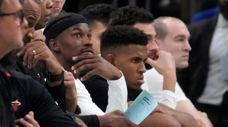 Miami Heat forward Jimmy Butler watches from the bench during...