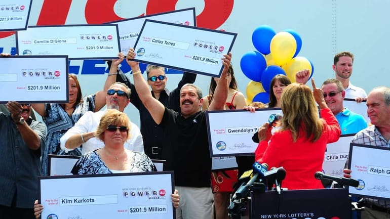 New York Lottery's Yolanda Vega awards the $201.9-million Powerball jackpot...