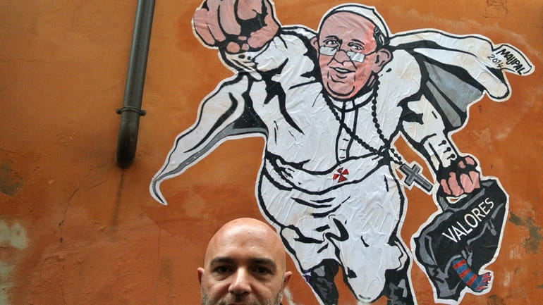 Italian artist Mauro Pallotta poses in front of his graffiti...