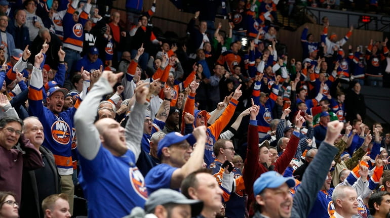 Islanders fans cheer a third-period goal against the Canadiens at...