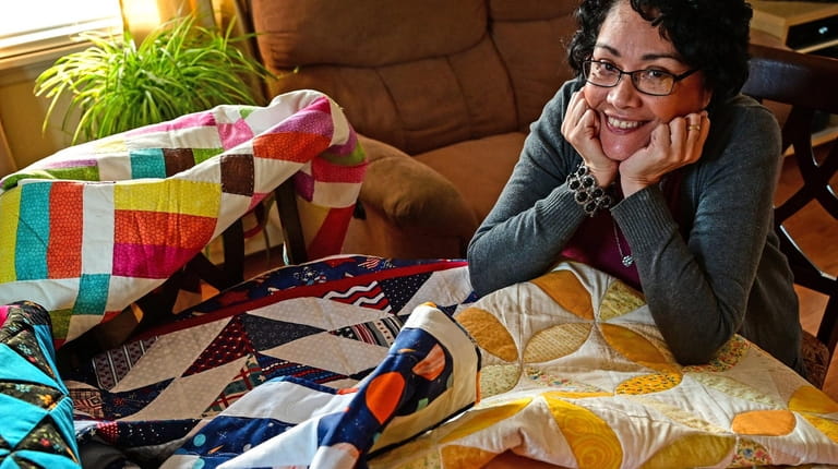 Nivia E. Maldonado displays quilts in her Levittown home. Of...
