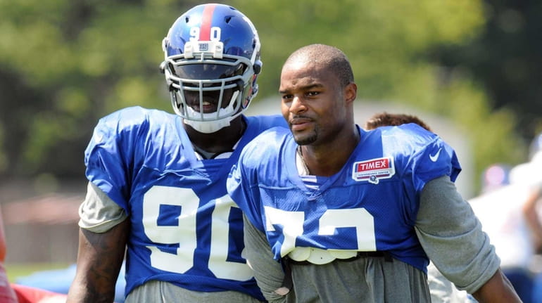 Giants defensive ends Jason Pierre-Paul, left, and Osi Umenyiora look...