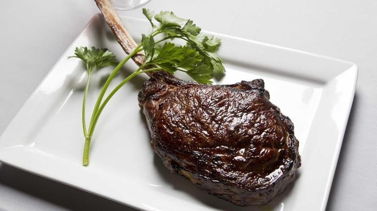 Bone-in-rib steak is served simply at Insignia Prime Steak and...