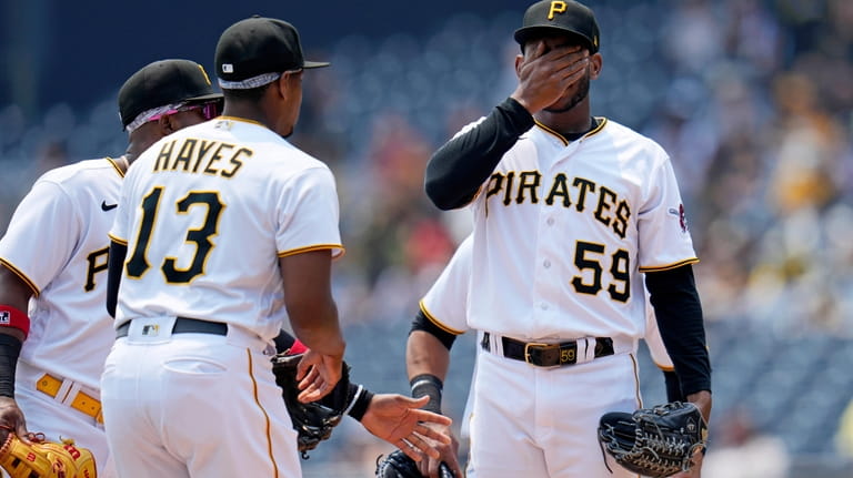 Pittsburgh Pirates starting pitcher Roansy Contreras (59) wipes his face...