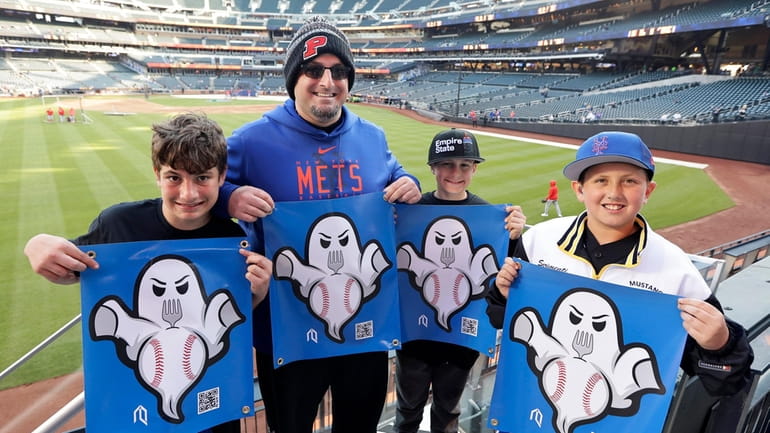 New York Mets fans Chris Blumenstetter, with his sons Michael...