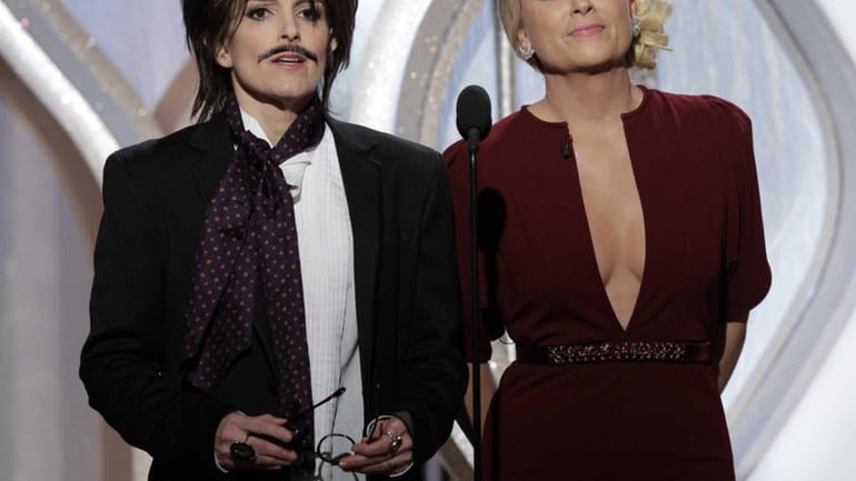 From left, co-hosts Tina Fey and Amy Poehler on stage...