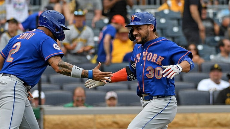 Michael Conforto #30 of the Mets celebrates with Dominic Smith...
