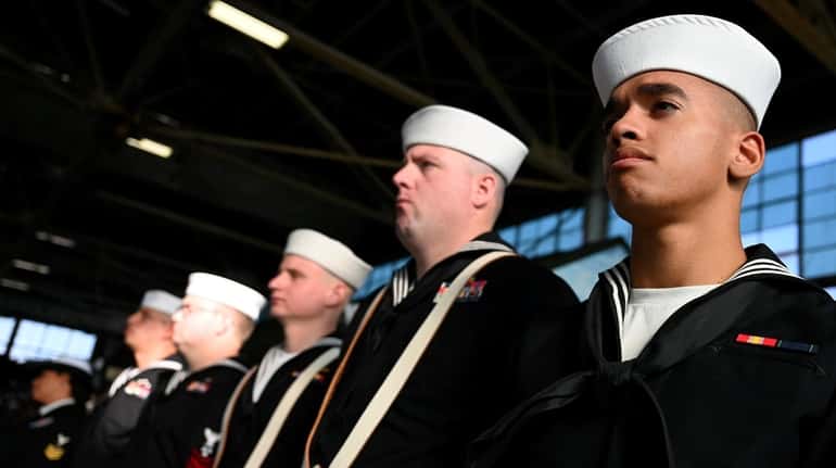 Gideon Sherry, 21, of Farmingdale, right, a Navy reservist, attends...