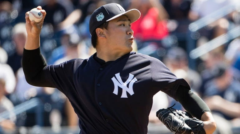 New York Yankees starting pitcher Masahiro Tanaka pitches during the...
