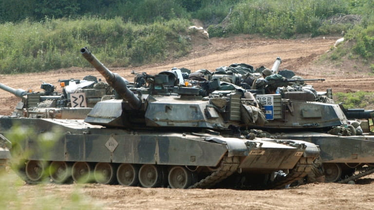 US tanks M1-A1 Abrams block a path at a training...