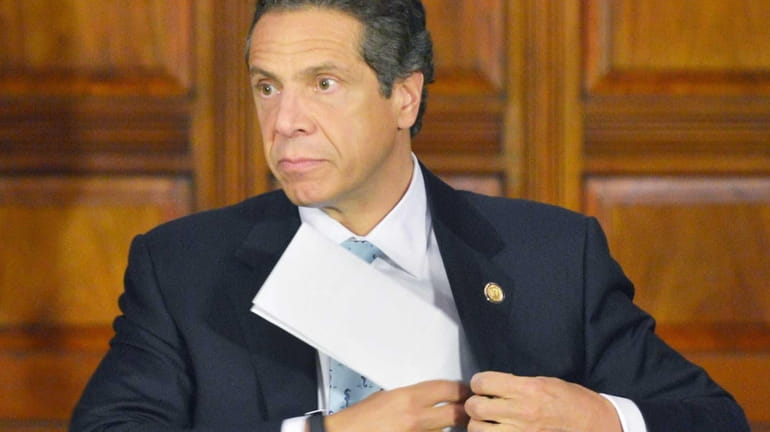 Gov. Andrew Cuomo pockets his notes as he finishes up...