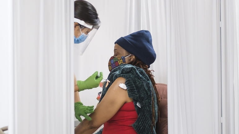 A woman receives the vaccine Monday at a pop-up site...