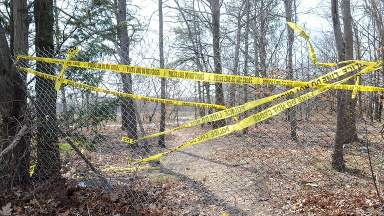 Crime tape covers an opening in a park on Clayton...