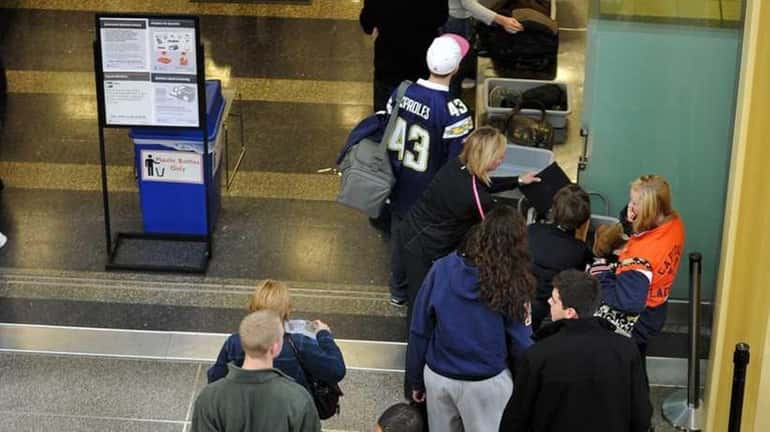 A file photo of travelers go through a Transportation Security...