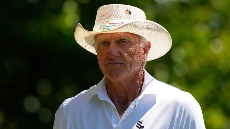 Greg Norman watches on the fourth hole during second round...