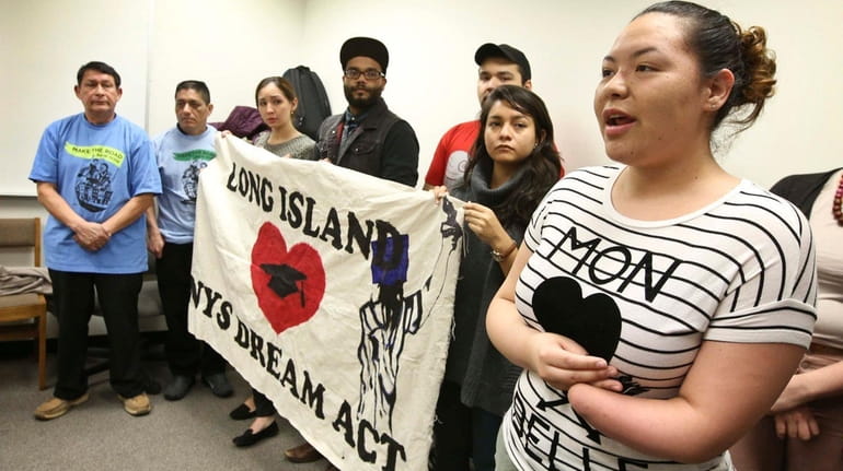 Marcy Suárez, 20, of Brentwood, right, joins other immigrant advocates...