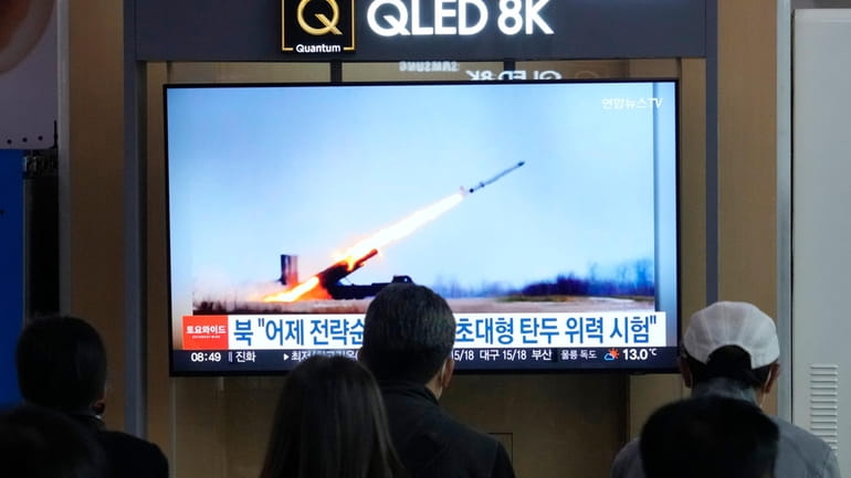 A TV screen shows an image of North Korea's missile...