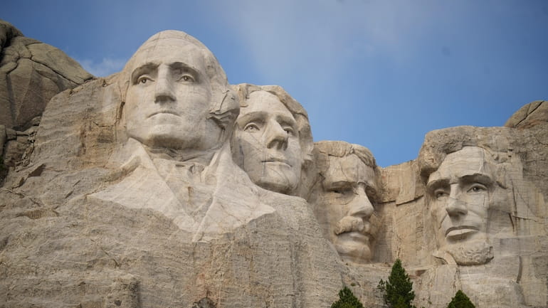 Visitors take in the massive sculpture carved into Mount Rushmore...