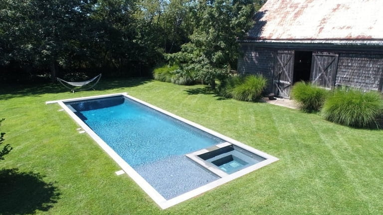 The pool and 19th century 1,700-square-foot post-and-beam barn.