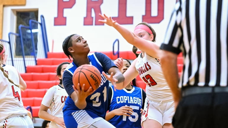 Destiny Johnson of Copiague readies her layup shot during a...