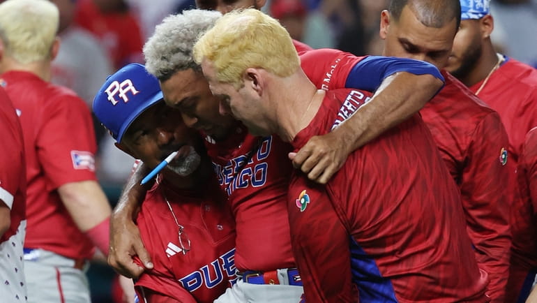Edwin Diaz of Puerto Rico is carried off the field after sustaining...