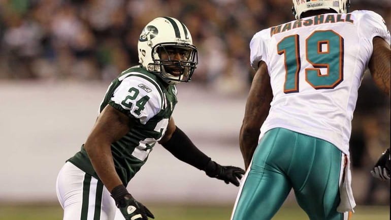 Darrelle Revis of the Jets defends against Brandon Marshall of...