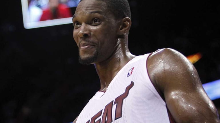 Miami Heat' Chris Bosh gives a thumbs up sign after...
