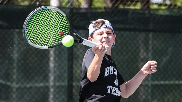 Drew Hassenbein of Roslyn returns a serve during his singles...