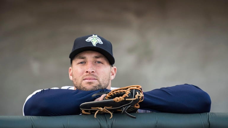 Columbia Fireflies outfielder Tim Tebow looks out from the dugout...