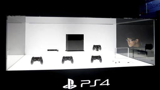 A show attendee looks at the new PlayStation 4 at...
