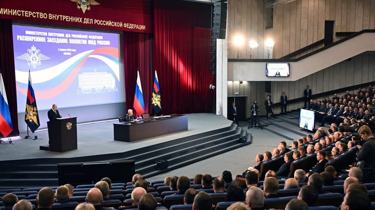 Russian President Vladimir Putin, left, addresses the annual meeting of...