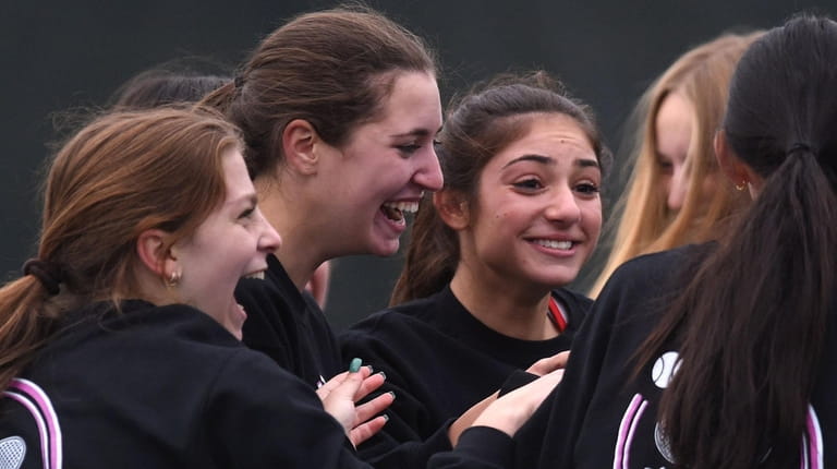 Half Hollow Hills East teammates celebrate after defeating Westhampton 4-3...