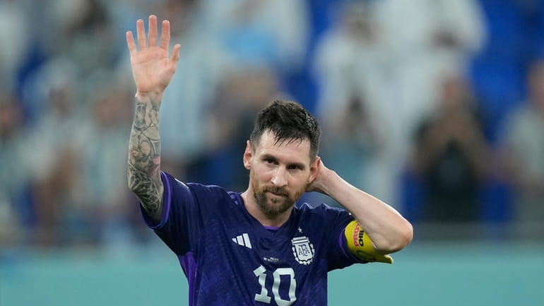 Argentina's Lionel Messi waves to the fans after the World...