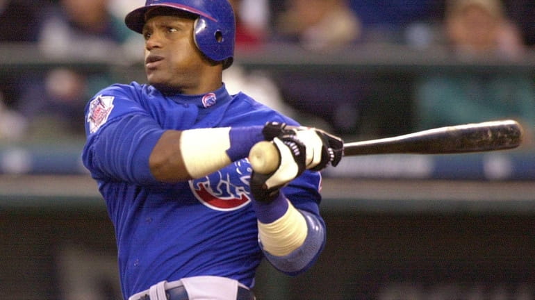 Chicago Cubs' Sammy Sosa watches his home run against the...