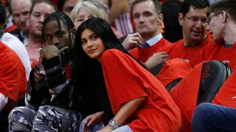 Houston rapper Travis Scott and Kylie Jenner watch courtside during...